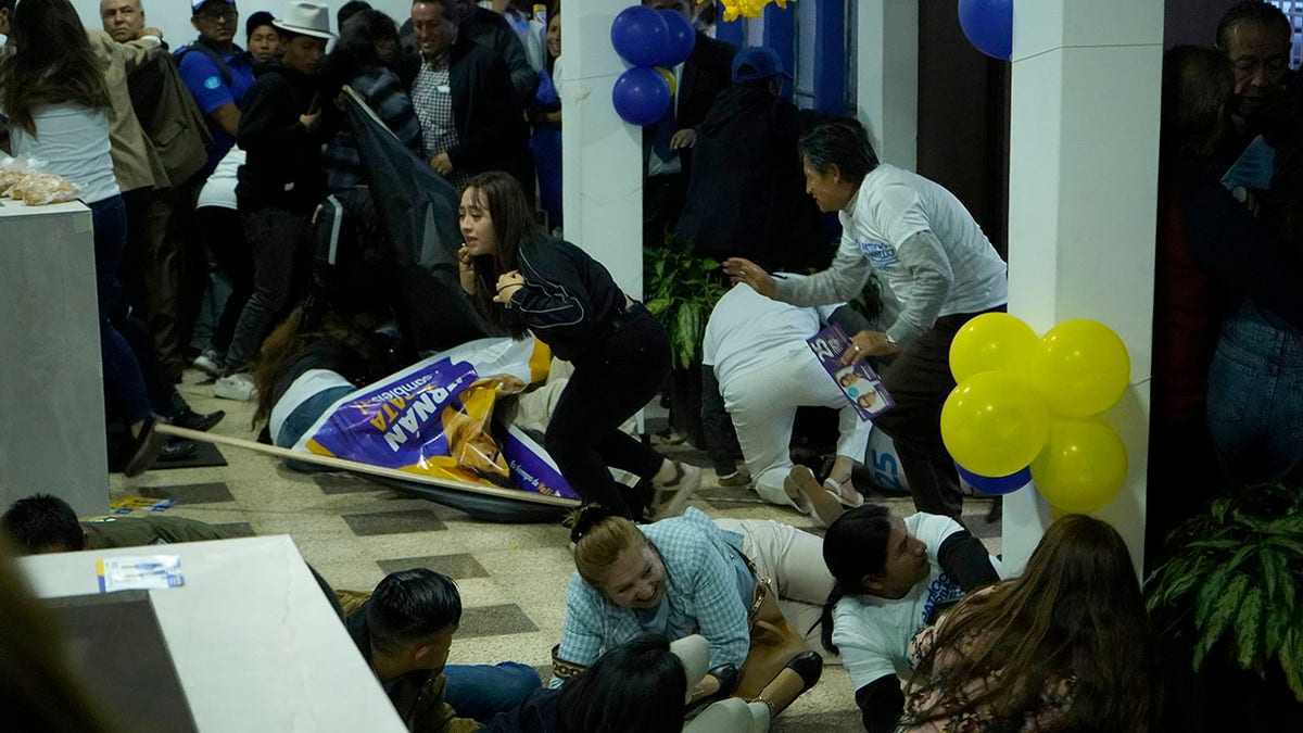 Supporters of Fernando Villavicencio take cover during shooting