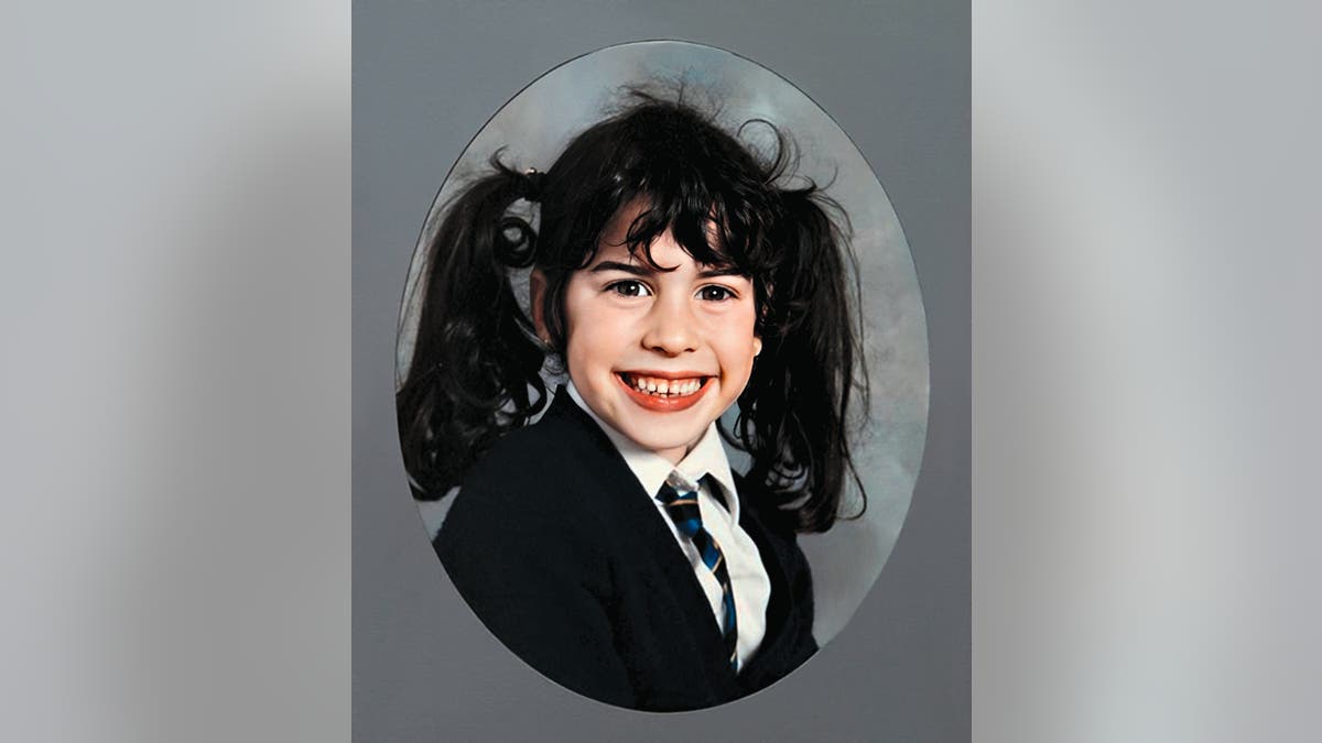A class photo of Amy Winehouse in pigtails