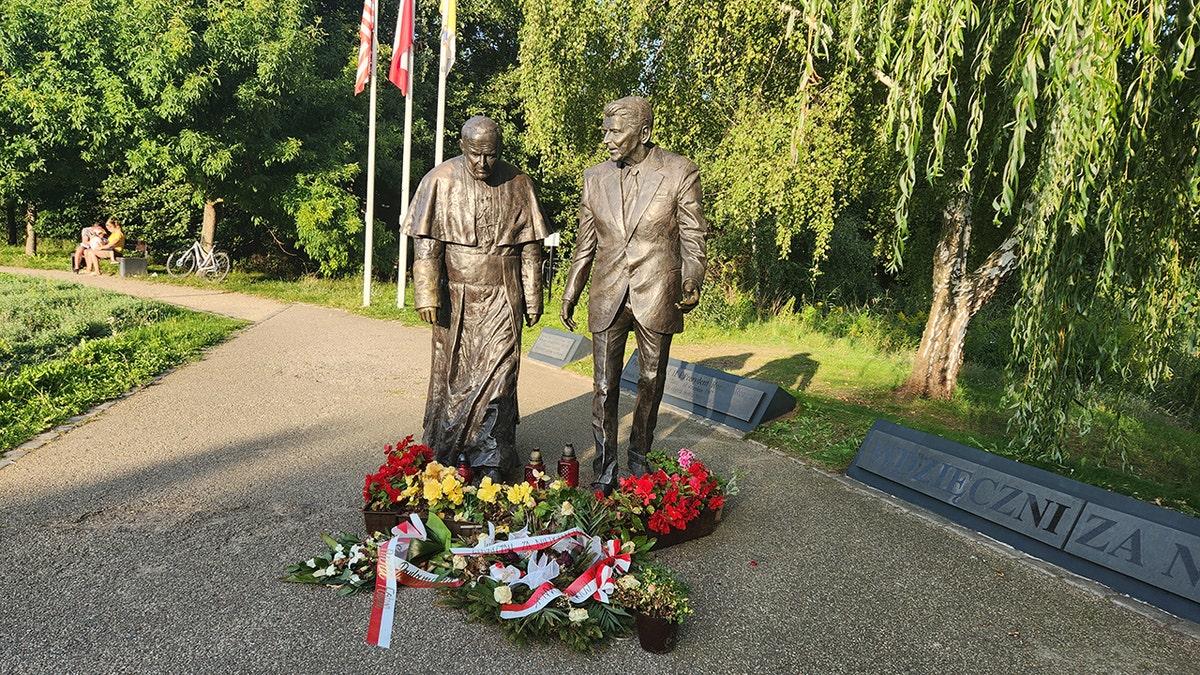 Two statues, one being President Ronald Reagan at a park in Gdańsk