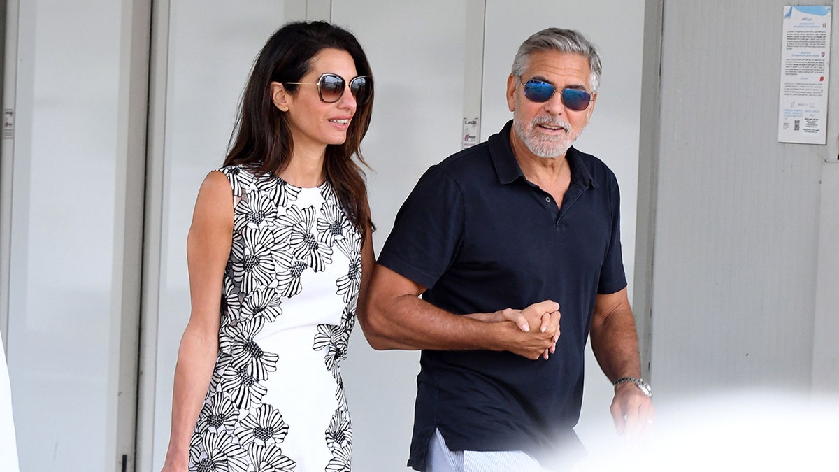 Amal Clooney and George Clooney walking together