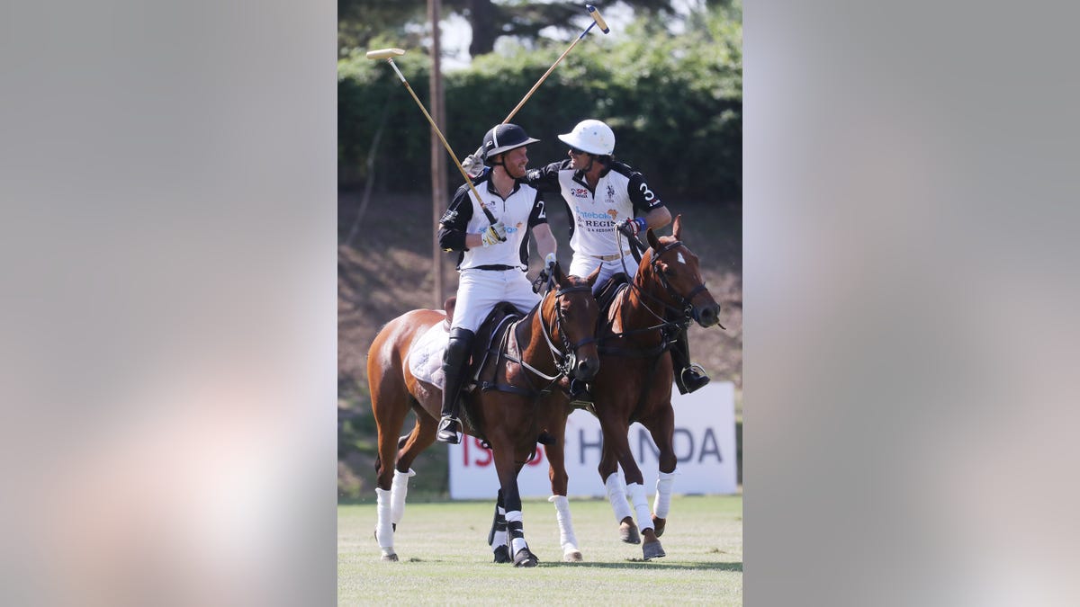 Prince Harry and Nacho Figueras on horses at a polo match