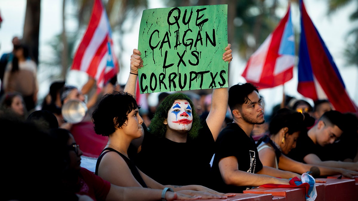 Puerto Rico protester holds corruption sign