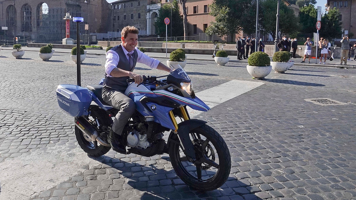 Tom Cruise riding a motorcycle in Italy