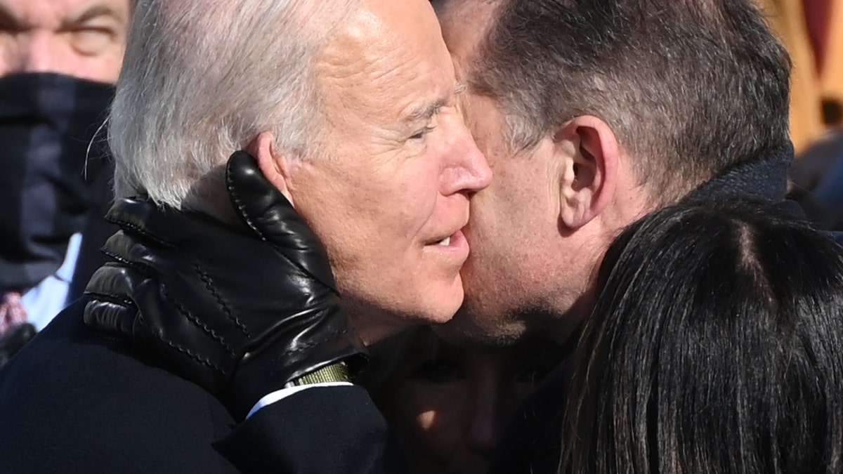 Joe Biden (L) embraces son Hunter