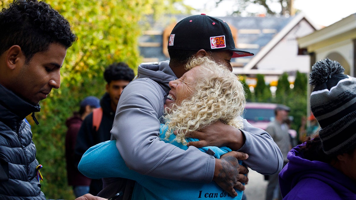 Martha's Vineyard resident hugs a migrant flown from Florida