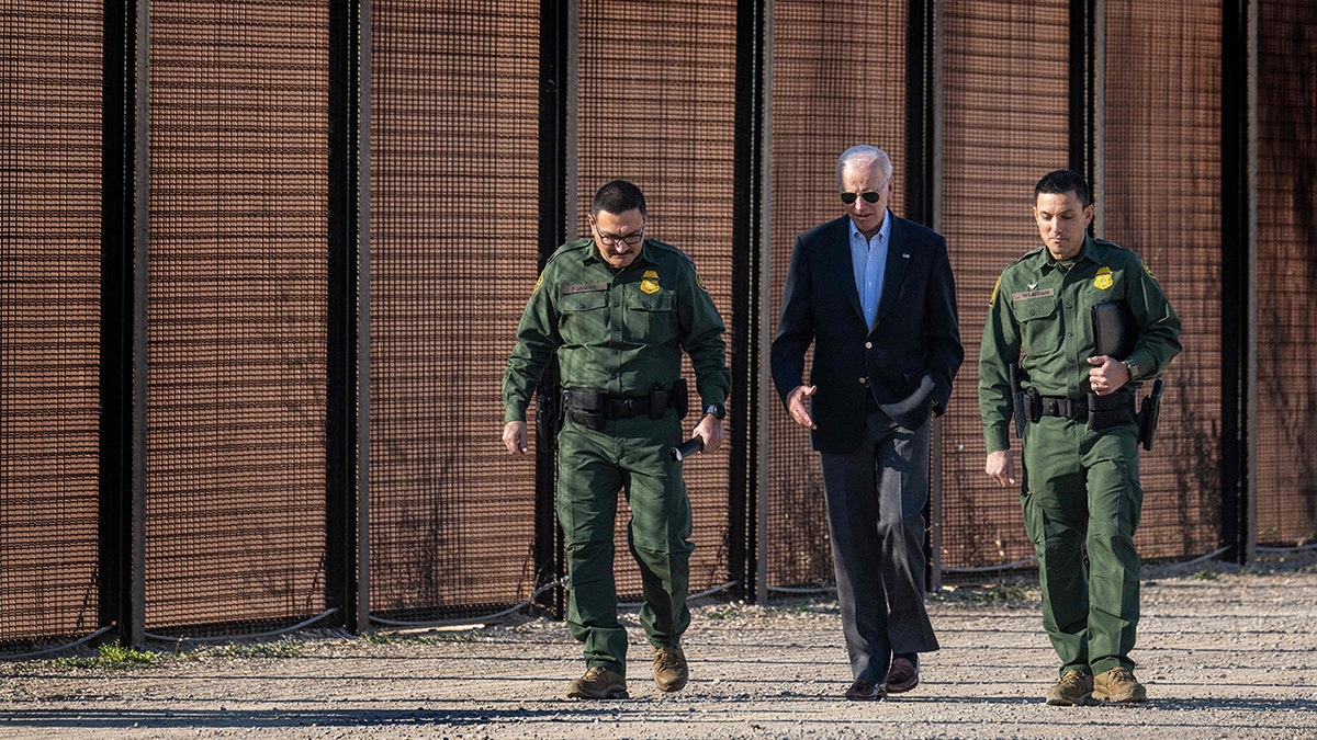 Joe Biden walking with CBP officers