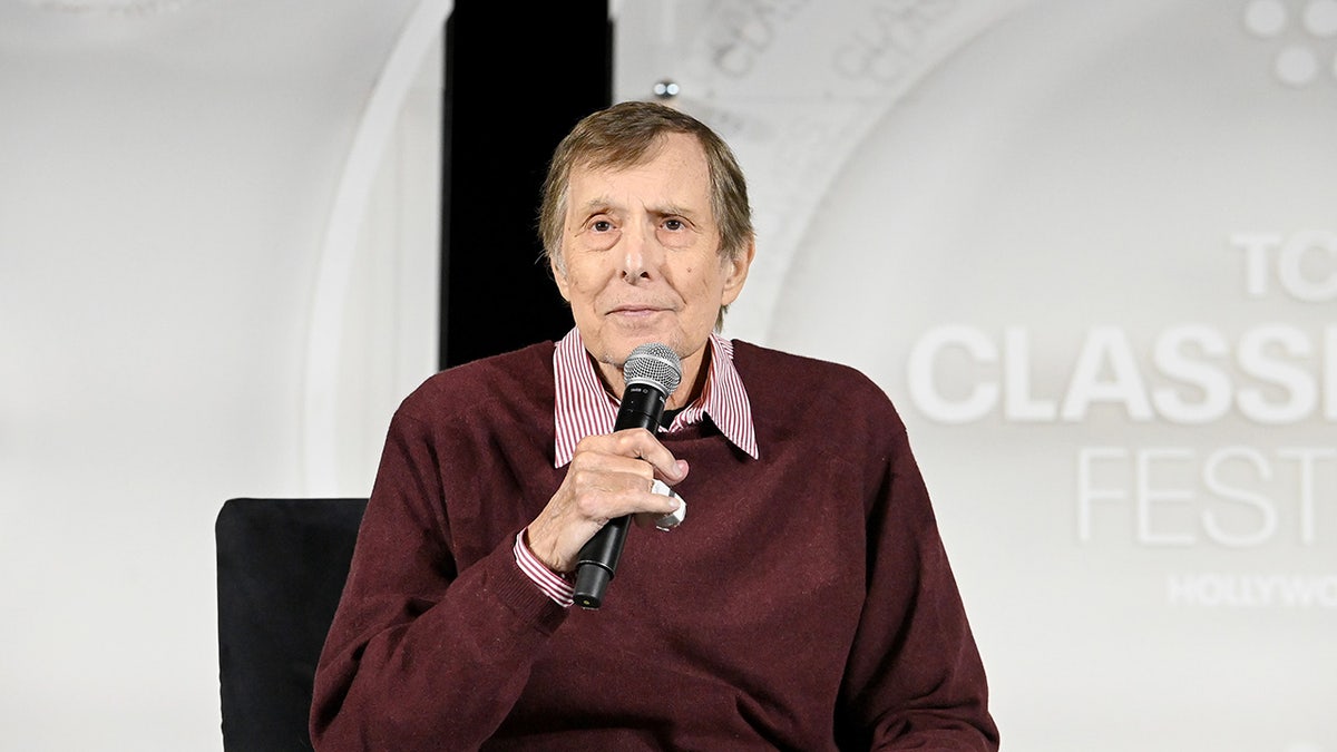 Director William Friedkin holds a microphone at Exorcist screening