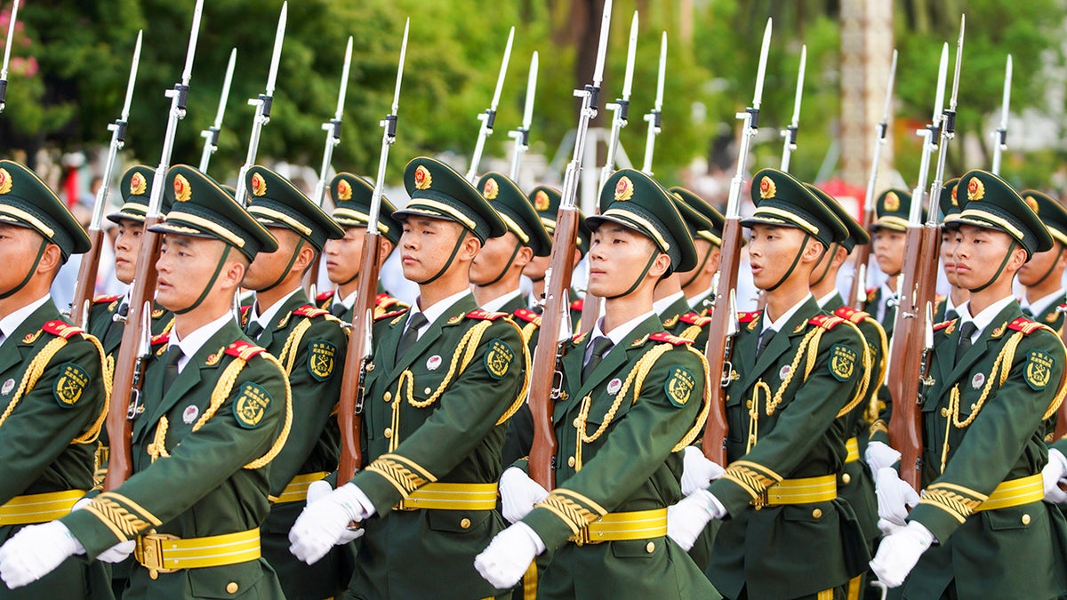Chinese soldiers march in a parade