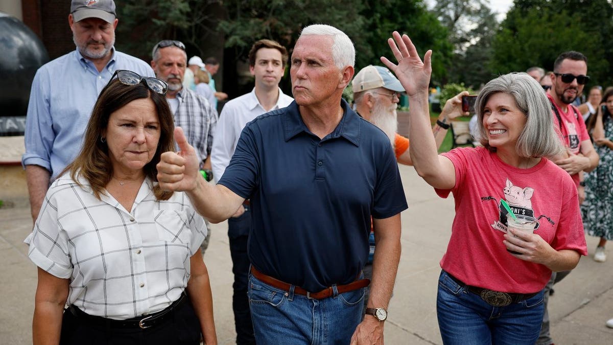Mike Pence (C) and his wife Karen Pence (L) and Sen. Joni Ernst (R-IA)