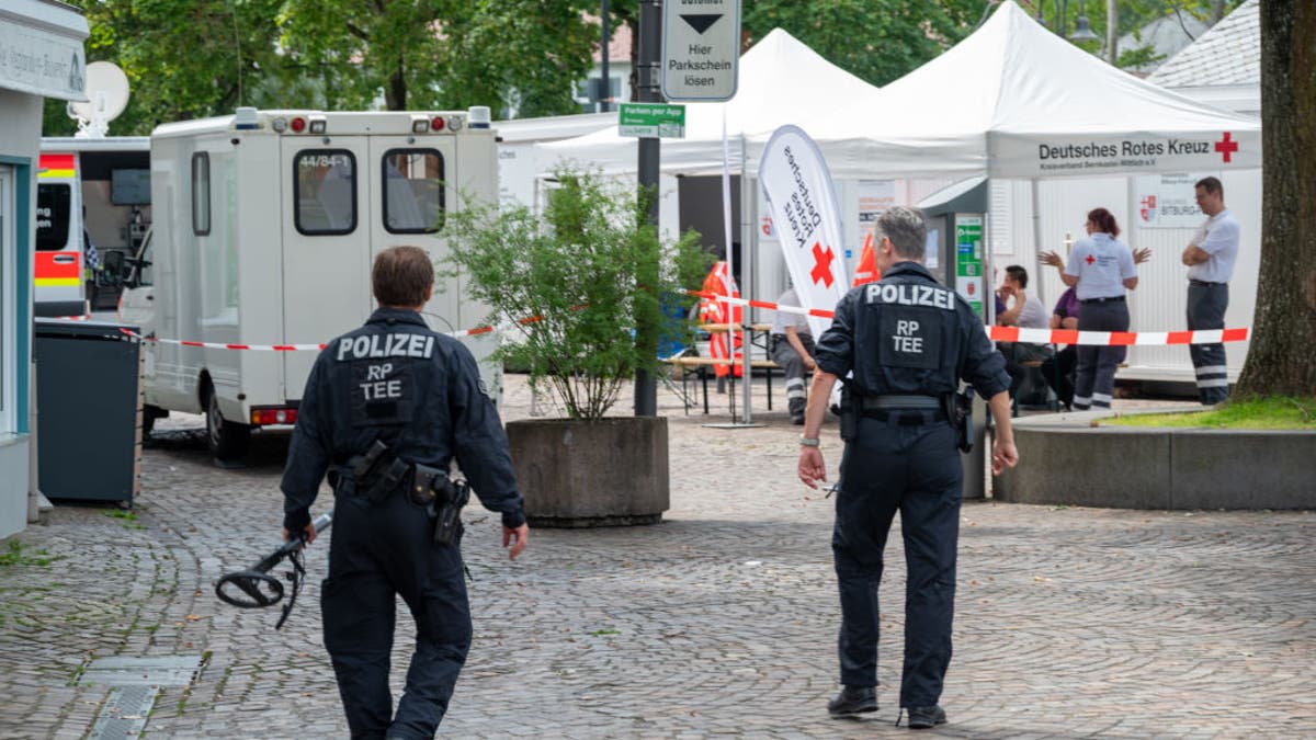 German police walk the stabbing crime scene