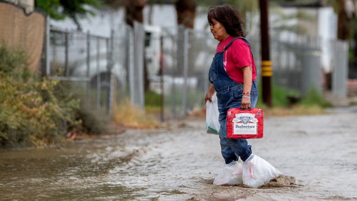 Woman walking in California flood