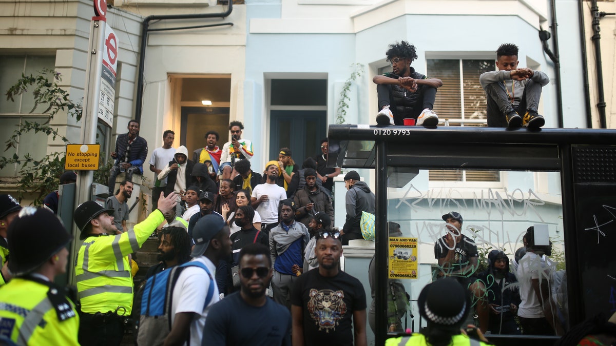 police officers try to control attendees during the notting hill carnival