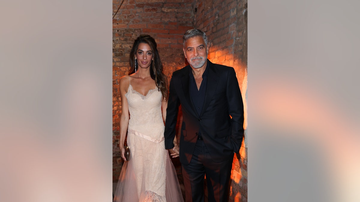 Amal Clooney walking with George Clooney