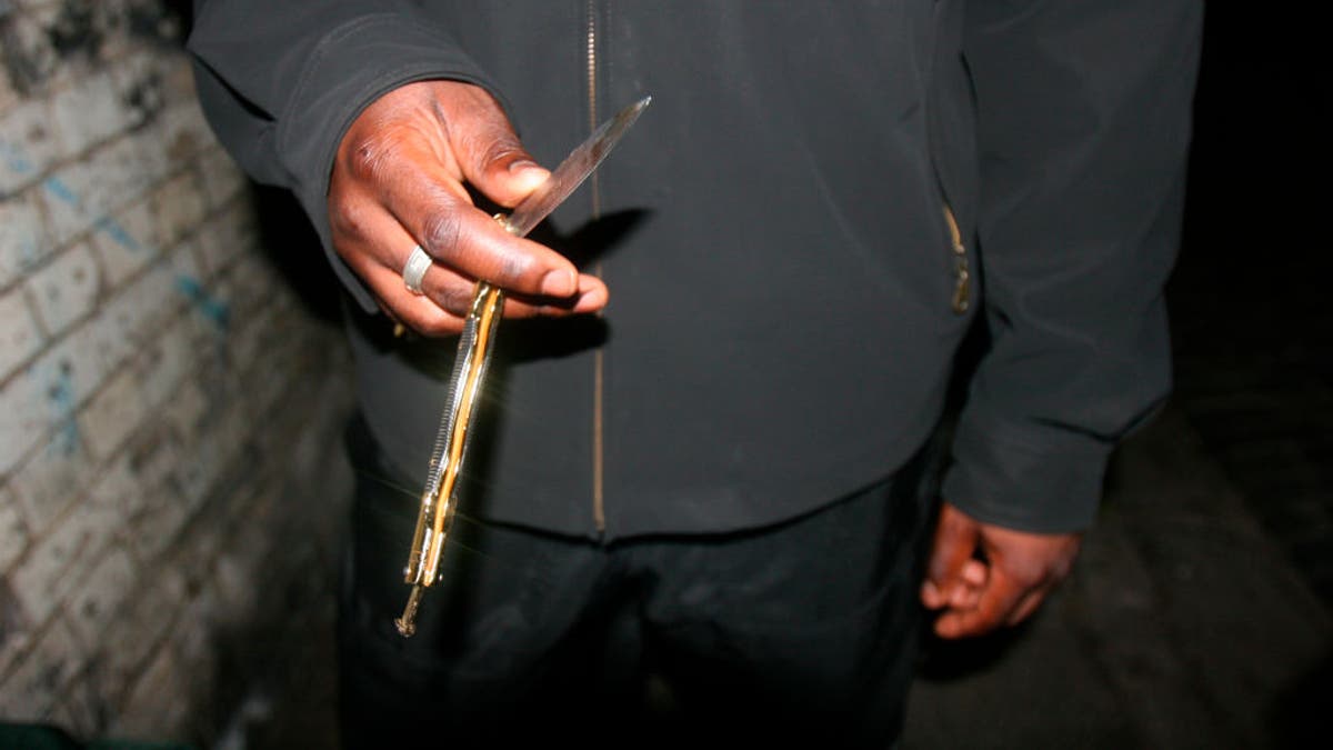close-up on man holding butterfly knife in hand