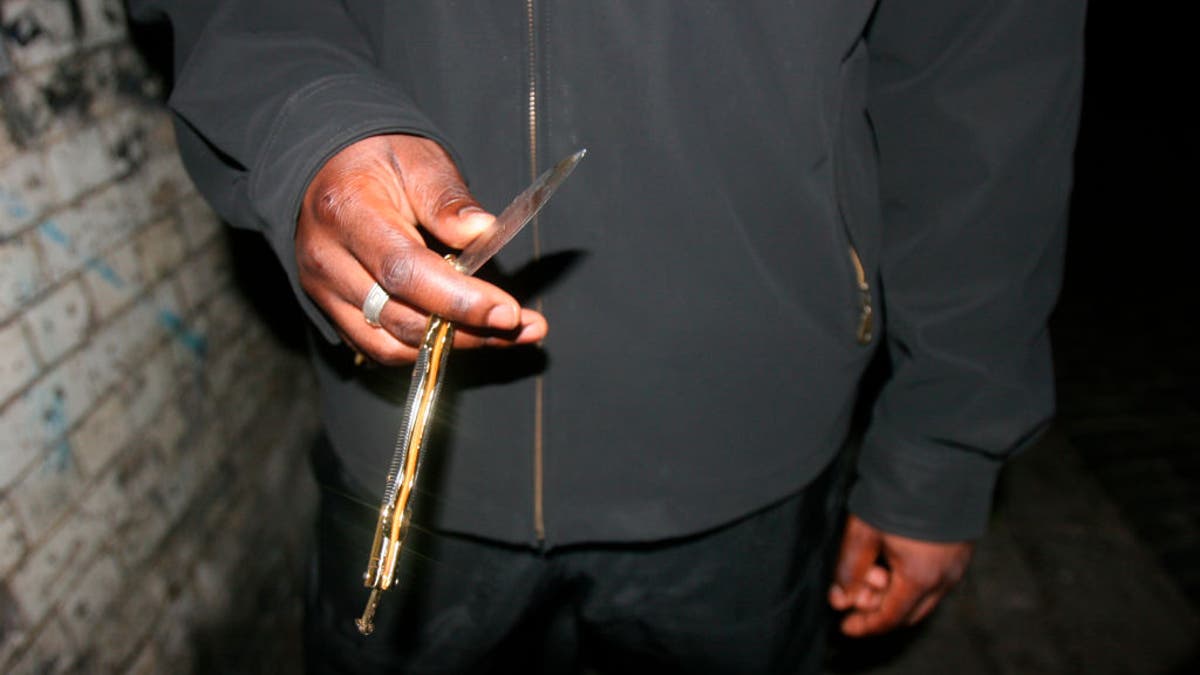 close-up on man holding butterfly knife in hand