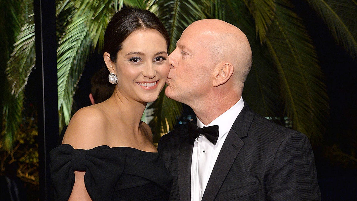 A photo of Bruce Willis kissing Emma Heming