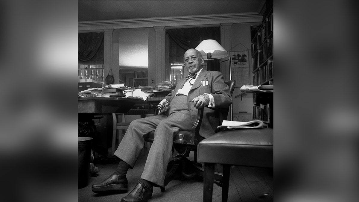W.E.B. Du Bois seated at desk