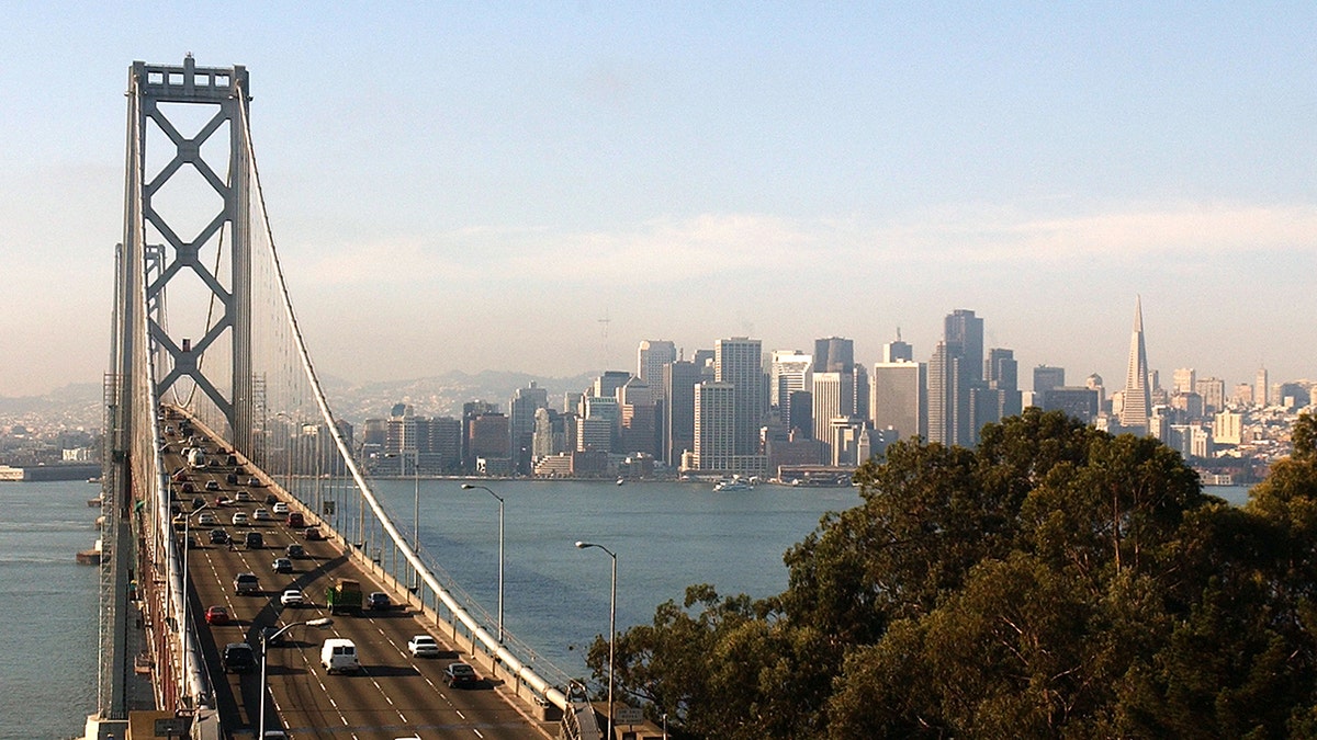 San Francisco Bay Bridge in foreground, SF skyline background
