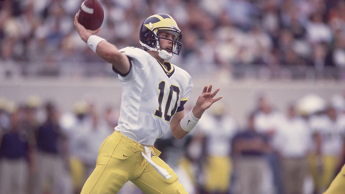 Tom Brady throws a pass in a Michigan Wolverines uniform