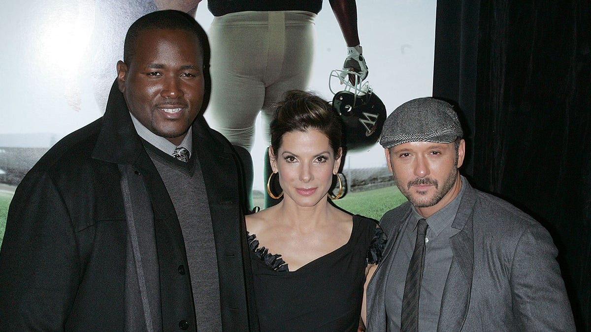 Quinton Aaron, Sandra Bullock and Tim McGraw at a premiere for "The Blind Side"