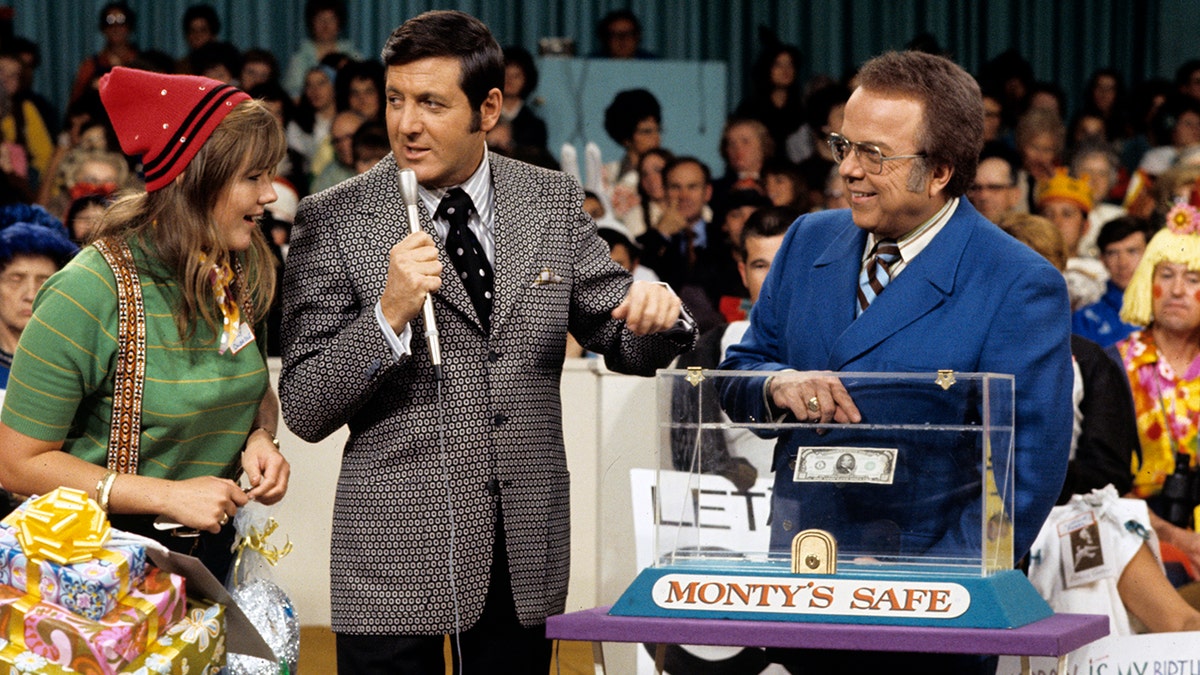 A contestant, Monty Hall, and Jay Stewart during a taping of Let's Make A Deal
