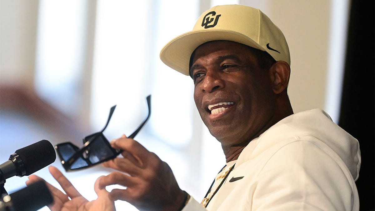 Deion Sanders speaks to reporters