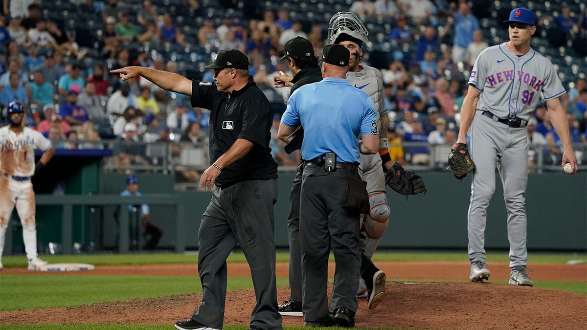 Umpire Marvin Hudson signals home the winning run