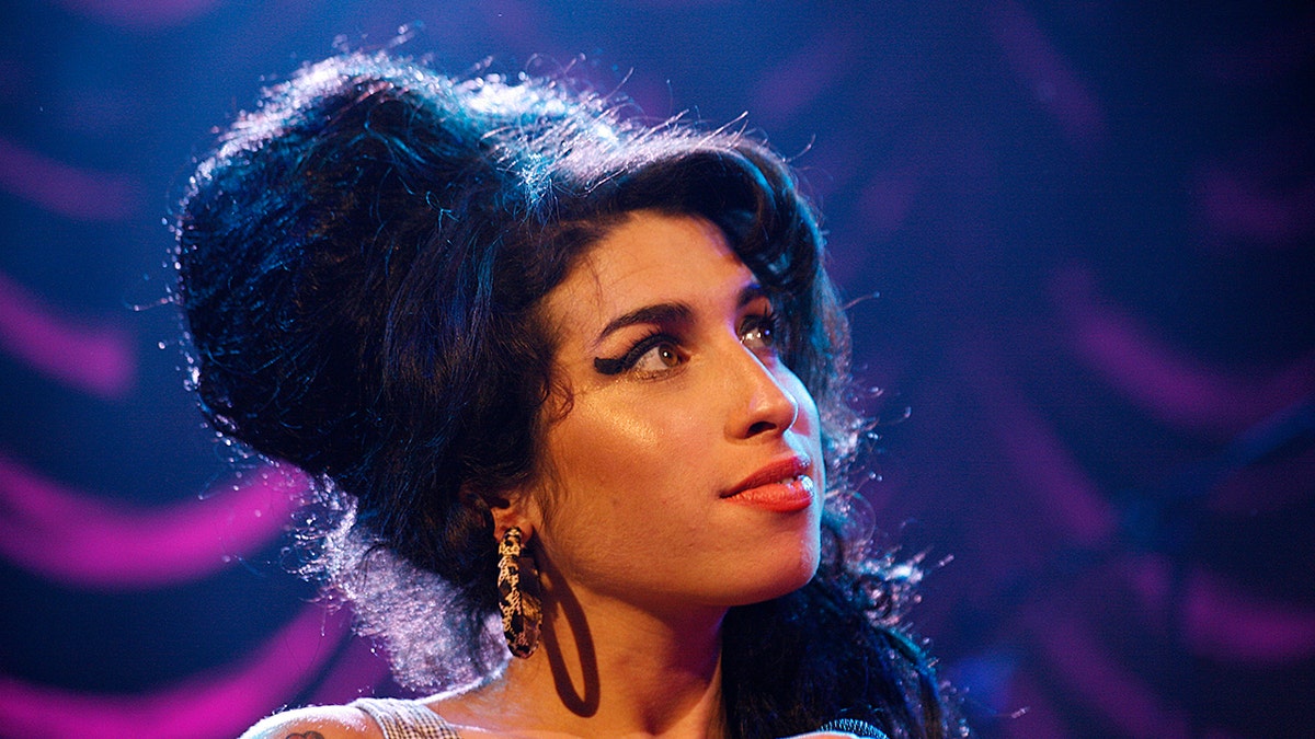 A close-up of Amy Winehouse on stage