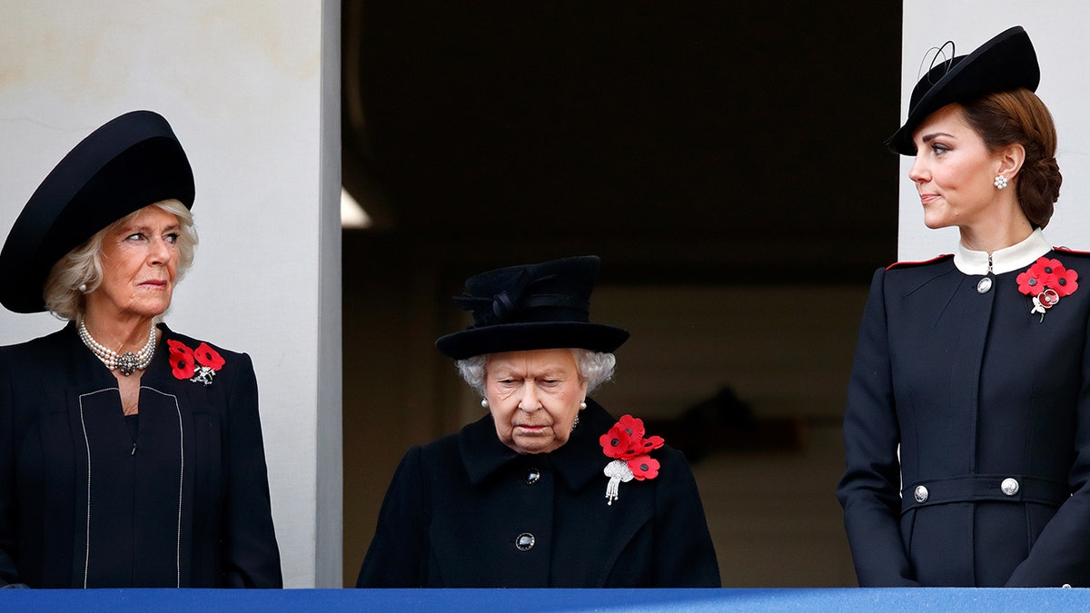 Camilla, Queen Elizabeth and Kate Middleton wearing black suits with red poppies