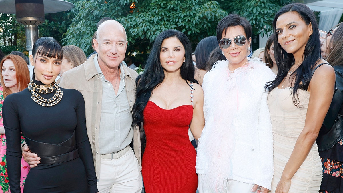 Jeff Bezos posing for a photo with Lauren Sanchez and the Kardashians