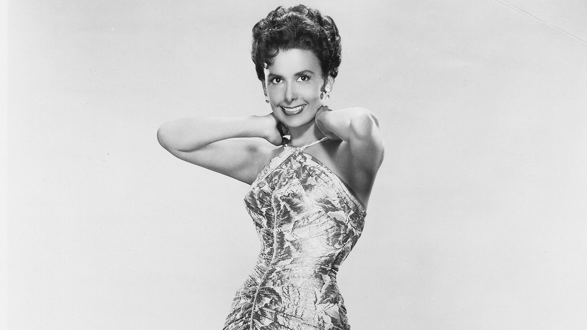 A close-up of Lena Horne in a criss-cross dress posing for a glamour shot