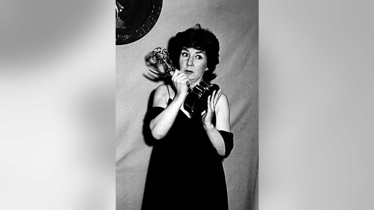 Maureen Stapleton holding her Emmy and looking surprised