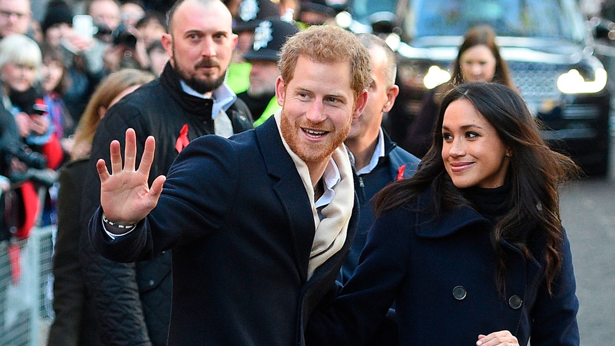 Prince Harry and Meghan Markle waving