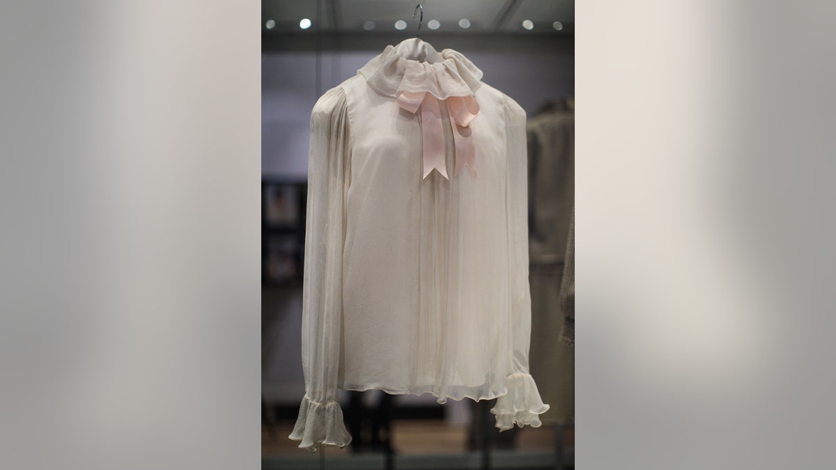 Princess Dianas white chiffon blouse with a pink bow