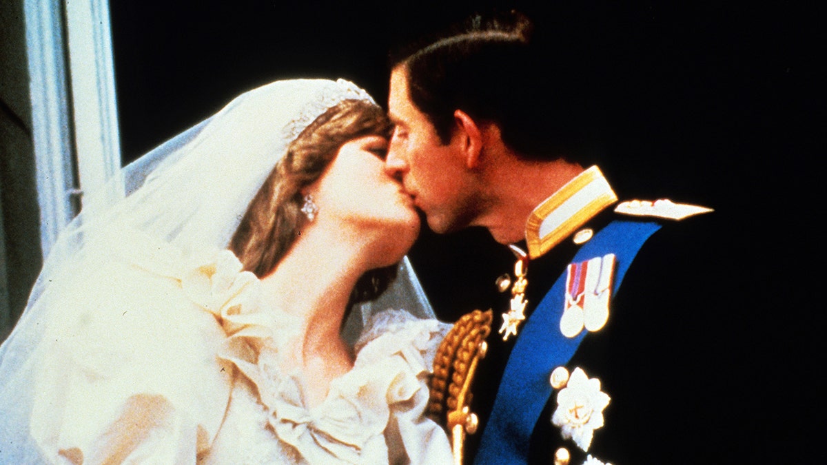 Princess Diana kissing Prince Charles on their wedding day