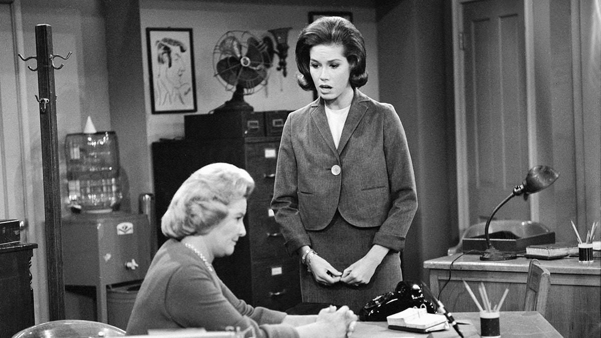 Mary Tyler Moore looking down at Rose Marie Marie