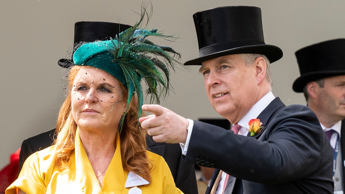 Sarah Ferguson wearing a yellow dress and a green hat standing next to Prince Andrew in a suit and top hat