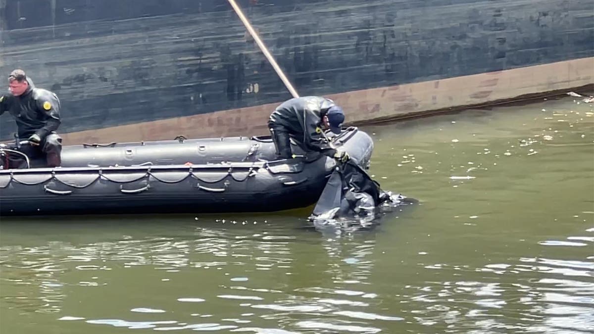 NYPD boats in the water coordinate to lift the body onto the boat