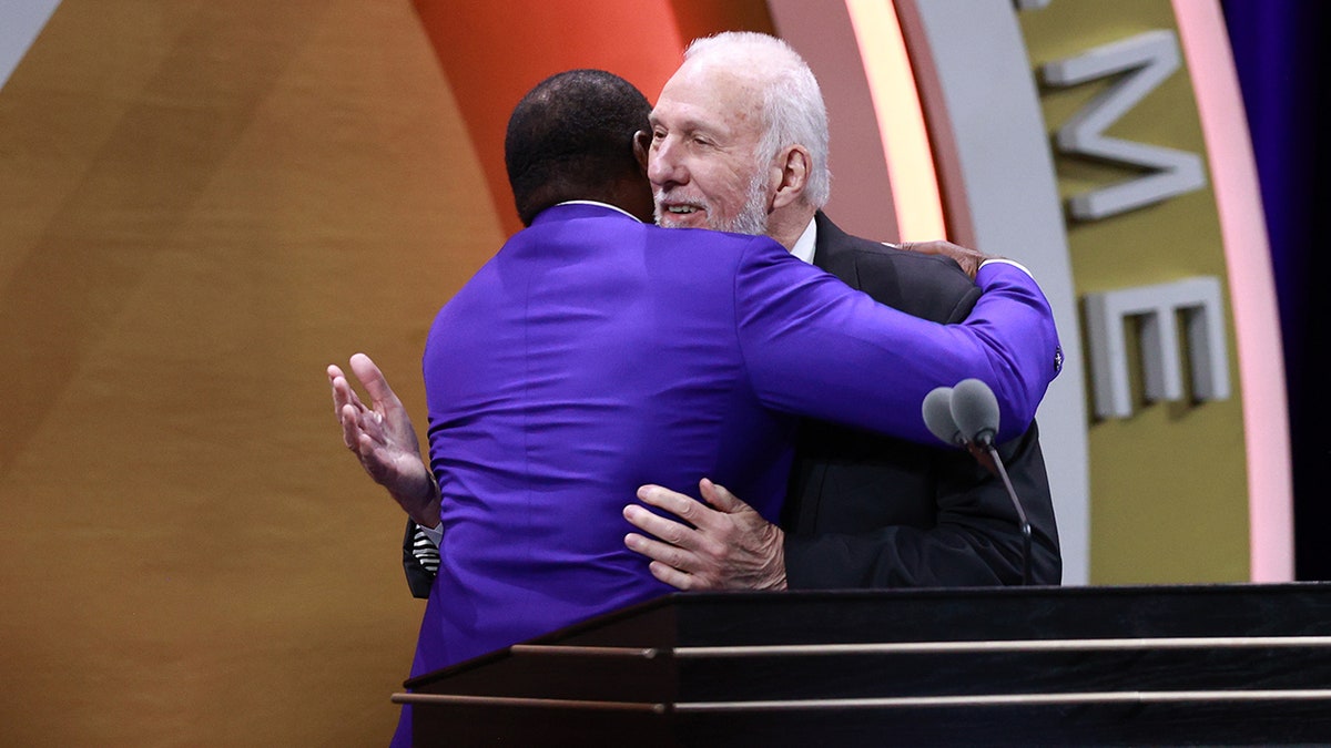 Ahmad Rashad hugs Gregg Popovich