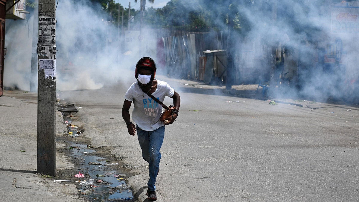 Man runs from tear gas