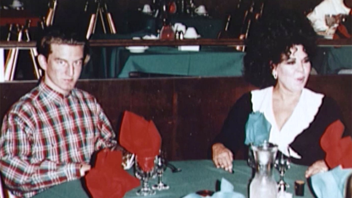 Kenneth Kimes wearing a plaid shirt sitting next to his mother Sante Kimes wearing a black and white dress