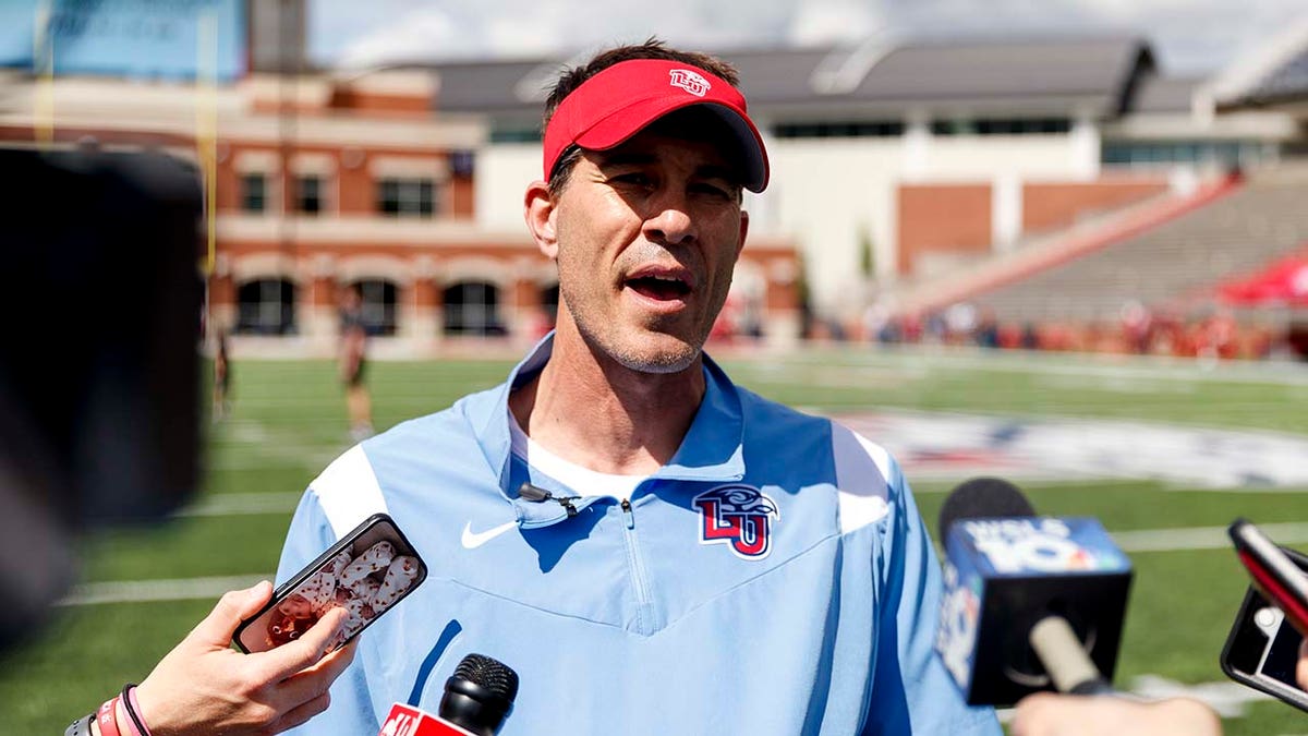 Liberty coach Jamey Chadwell speaks to the media
