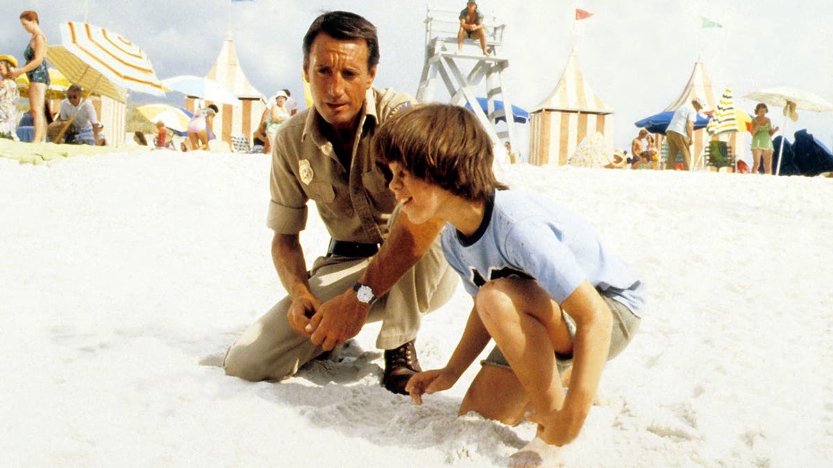 Roy Scheider and Marc Gilpin on the beach in "Jaws 2"