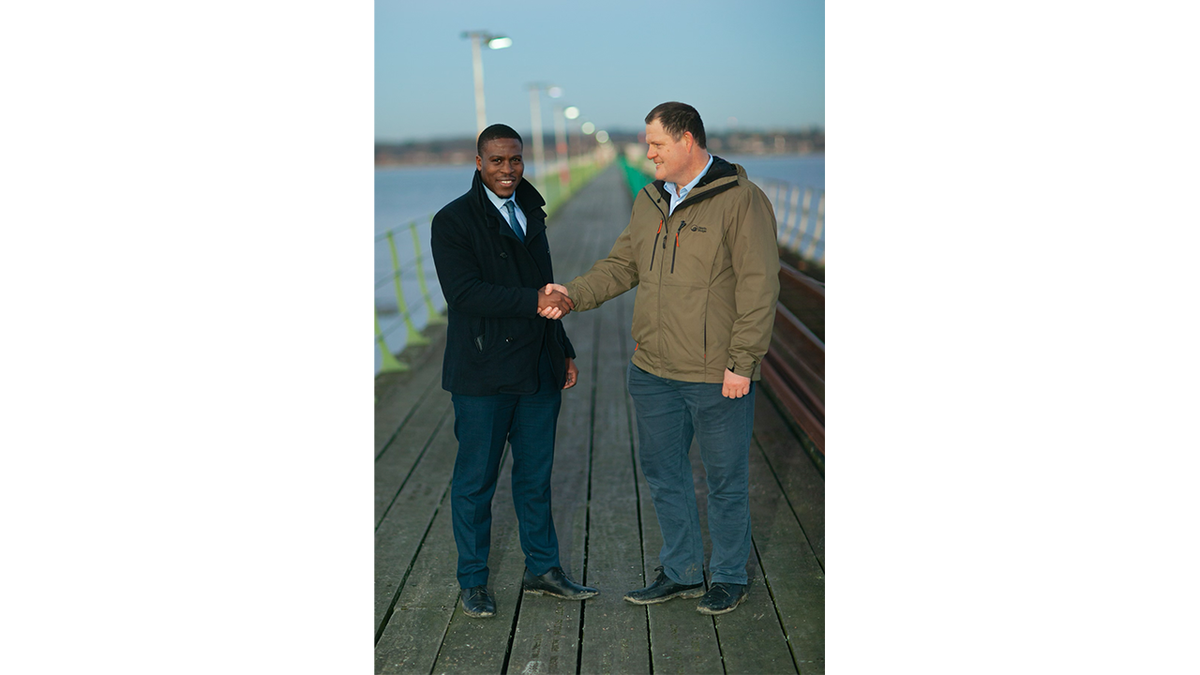 attorney Jeremiah Ingunnbole, left, shaking hand of Adam Smith-Connor