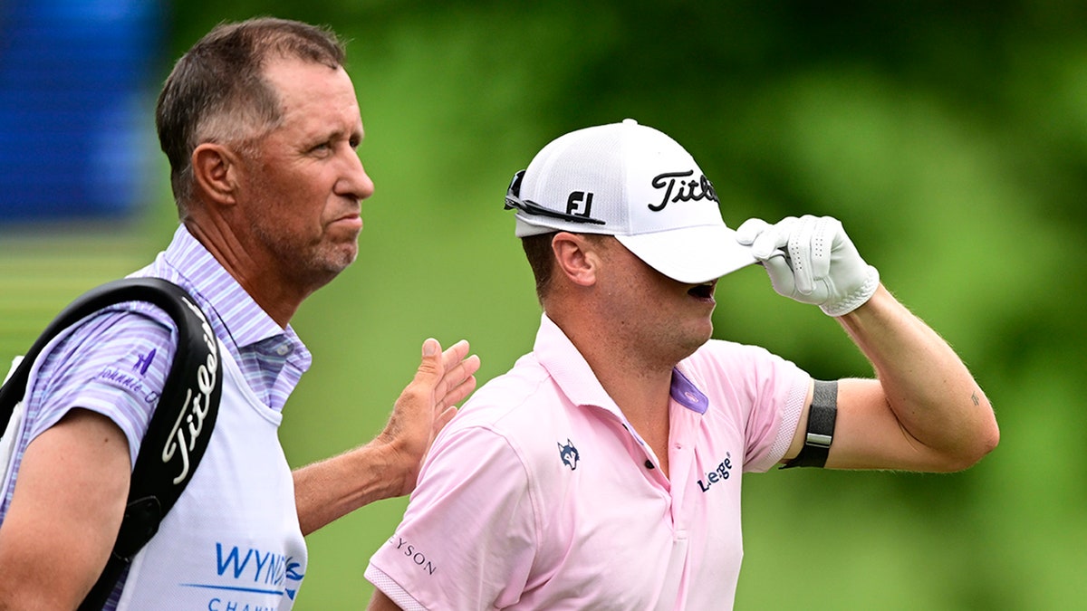 Justin Thomas reacts with caddie