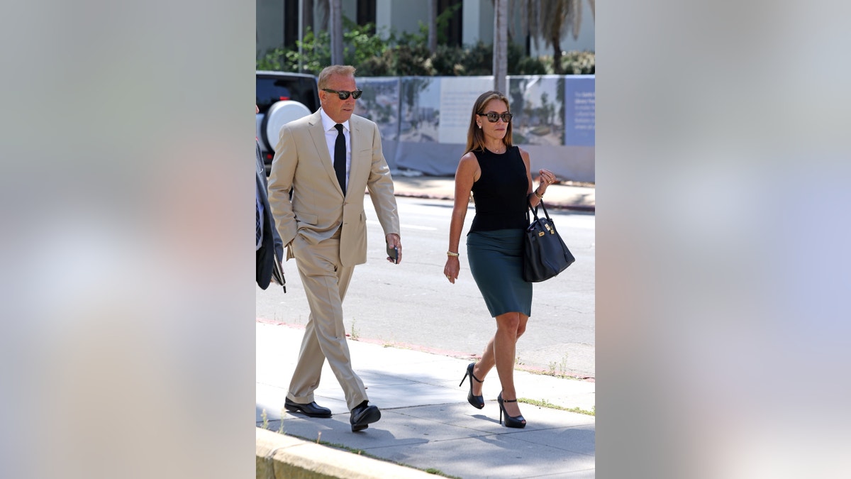 Kevin Costner wears a tan suit to court