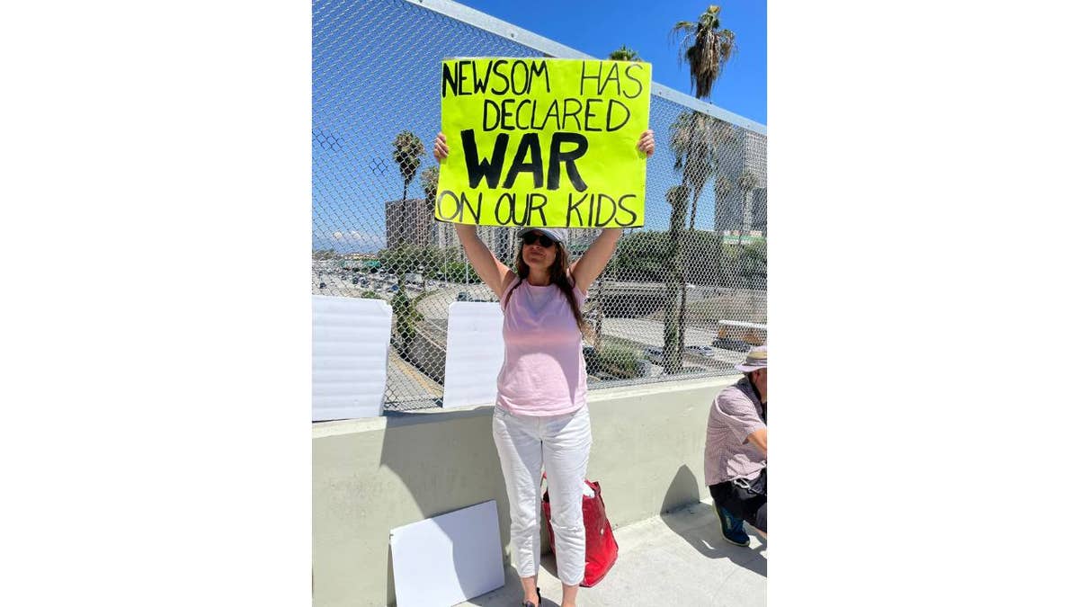 Woman holds up sign in LA protest