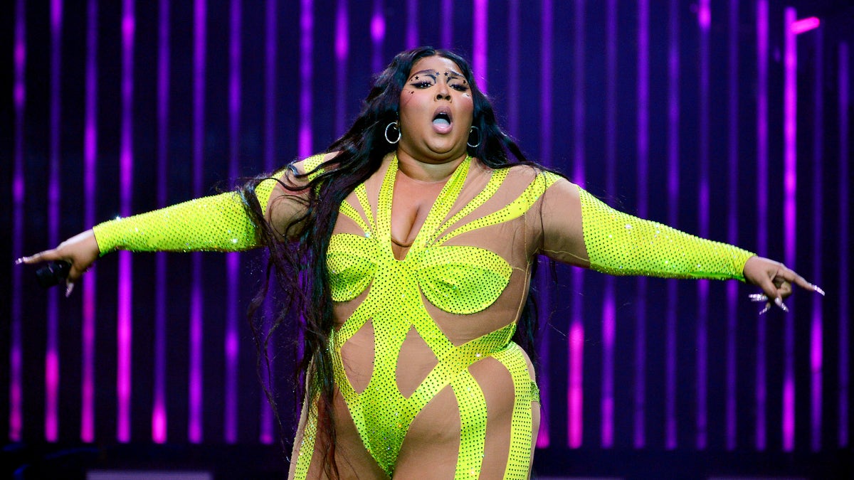 Lizzo in yellow outfit on stage