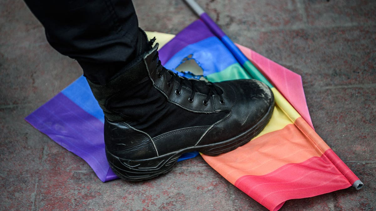 A foot over an LGBT flag