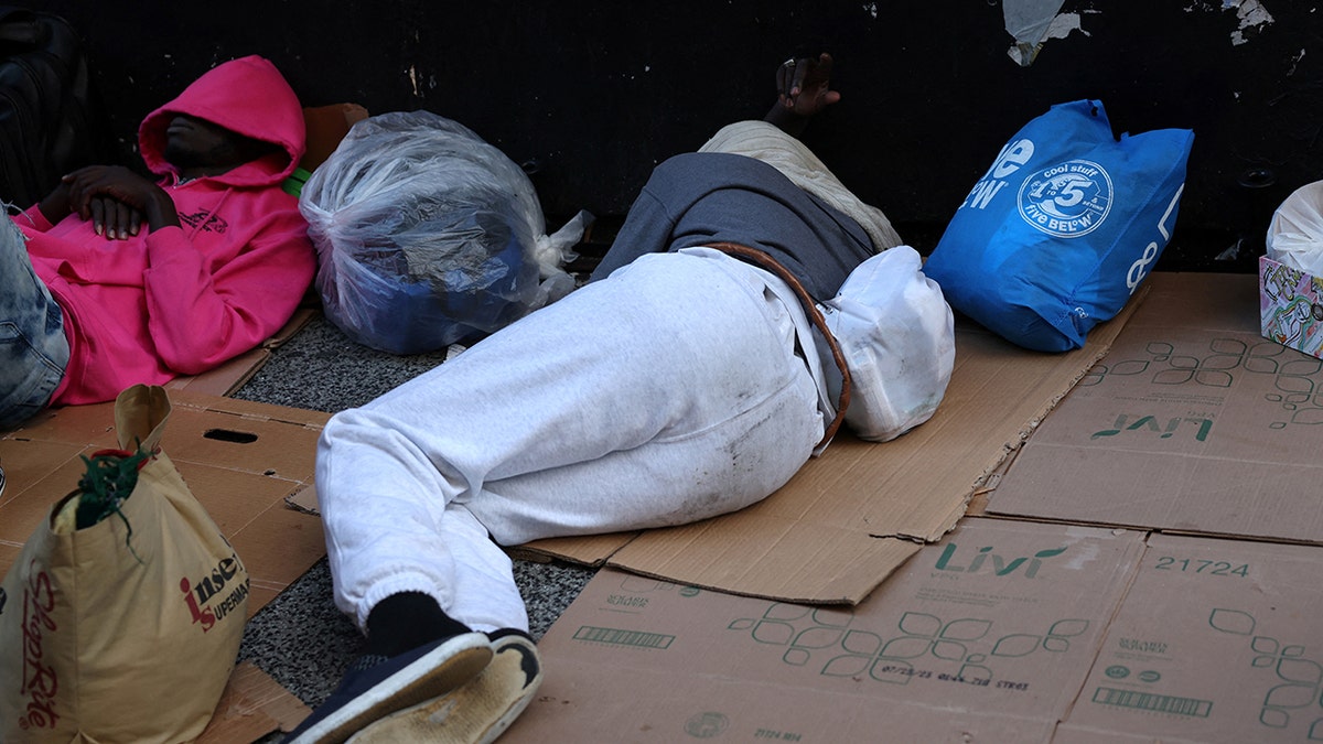 Migrants sleep outside Rosevelt hotel
